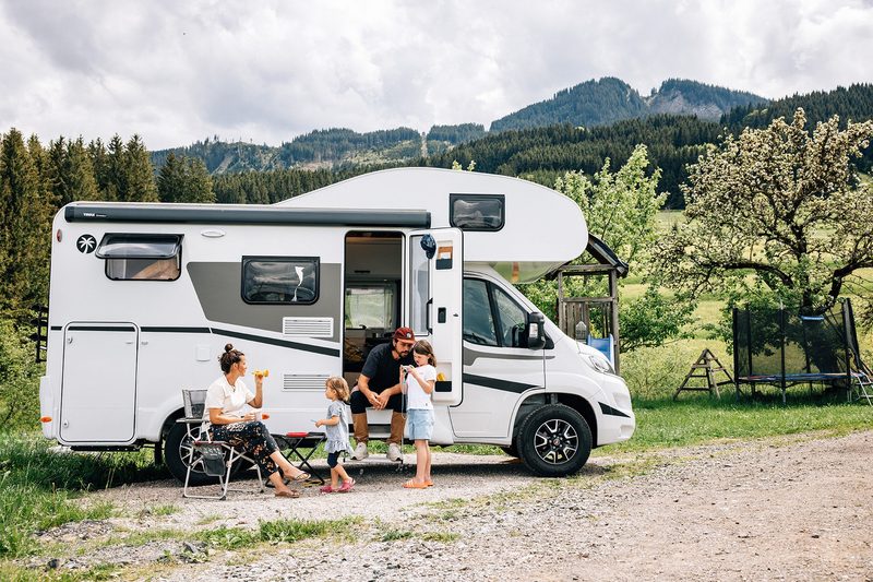 Family enjoying a McRent Sunlight motorhome in the Alps